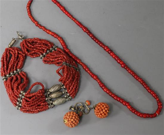 A pair of coral cluster earrings, a coral necklace and one other necklace.